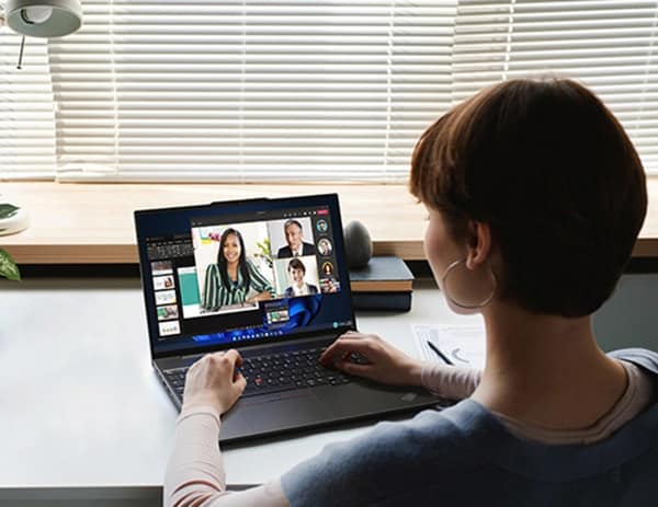 Person at a table or desk, using a Lenovo ThinkPad E16 (16